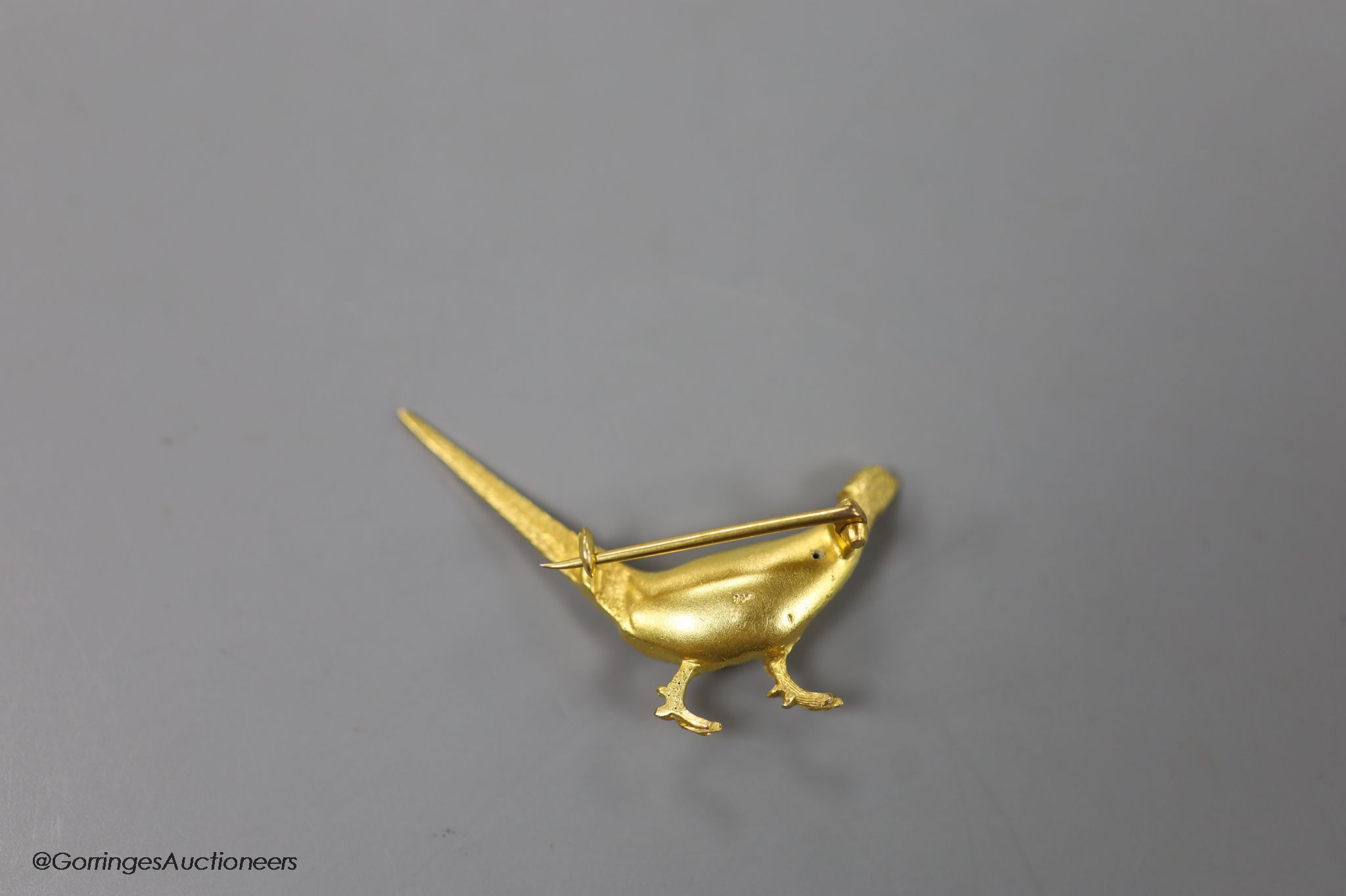 An early 20th century 9ct and polychrome enamel pheasant brooch, 42mm, gross weight 6.4 grams.